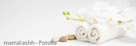 Spa orchid with soft towels and massage stones setting