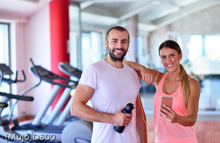 Young couple taking a sefie in a gym