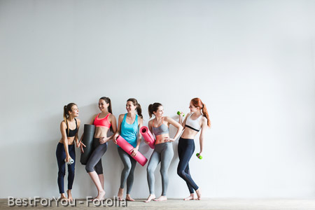Smiling women in fitness studio.