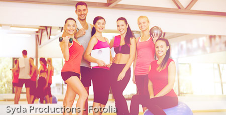 group of smiling people in the gym