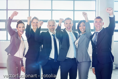 Businessman cheering with clenched fist