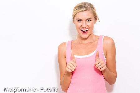 Happy young woman giving thumbs up