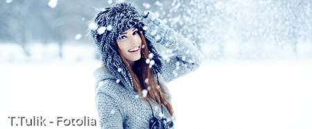 Girl playing with snow in park 