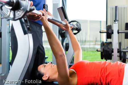woman and Personal Trainer in gym