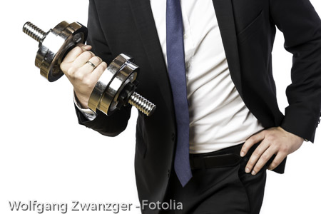 Businessman holding silver dumbbell