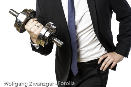 Businessman holding silver dumbbell