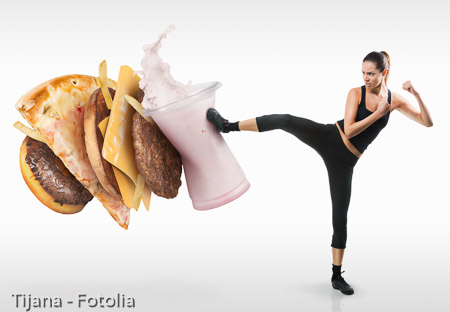 Fit young woman fighting off fast food