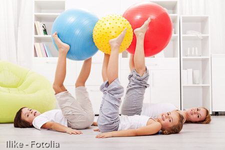 Healthy family exercising at home
