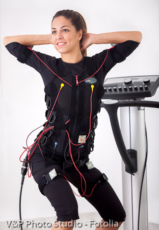 woman exercise trunk-bending forward  on  electro stimulation ma