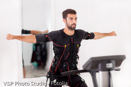 man working on electro muscular stimulation machine