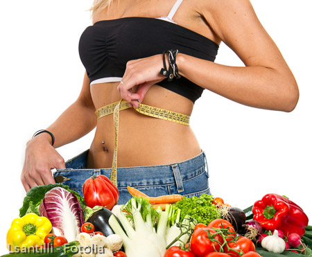 A slim girl measuring her waist