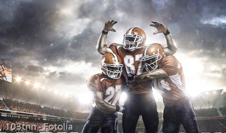 American football players in action on stadium