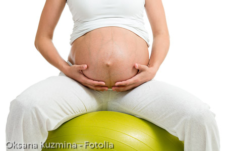 Pregnant woman excercises with gymnastic ball
