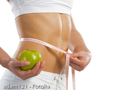 young athletic woman measuring waist