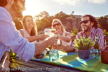 cheerful friends drinking cocktails