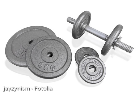 Fitness exercise equipment silver dumbbell and weights plate isolated on white background.