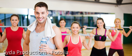 smiling trainer in front of group of people