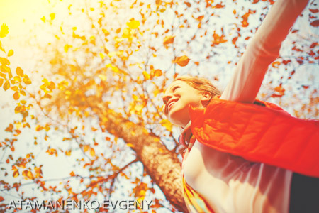happy girl enjoying life and freedom in autumn on nature