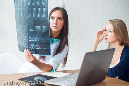 doctor and patient looking at x-ray or MRI concept healthcare