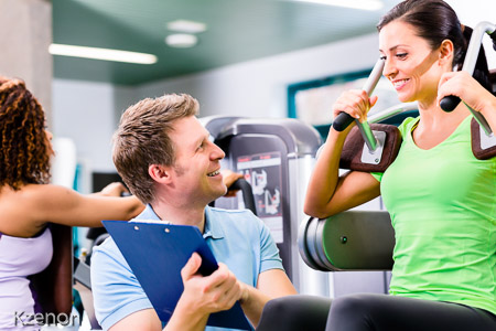 Woman with personal trainer doing sport und fitness